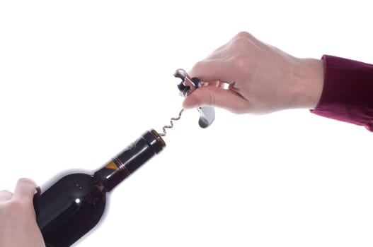 A red wine bottle is opened with a corkscrew