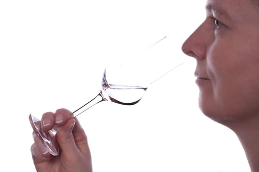 A woman enjoys a glass of liquor