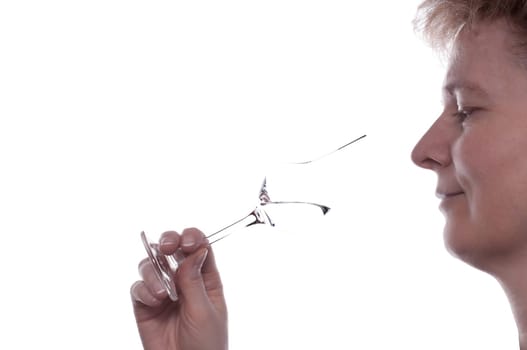 A blonde woman drinks a grappa from a grappa glass