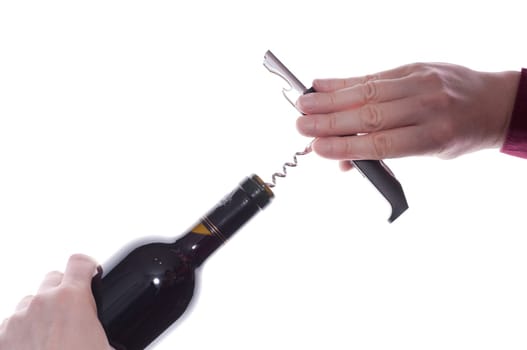 A red wine bottle is opened with a corkscrew