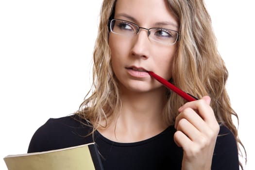 Young student with a pen and notebook thinking