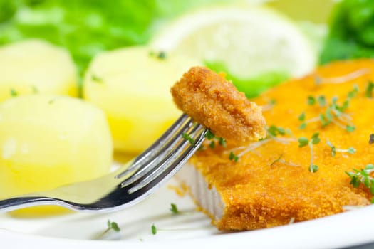 Piece of a fried cutlet on a fork