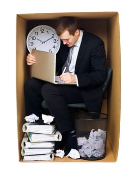 Businessman in a very tight office isolated on white background