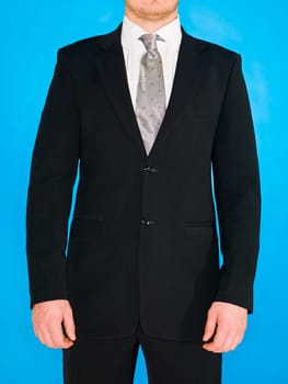 Part of a well dressed man on blue background