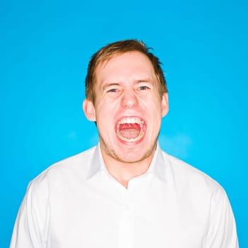 Portrait of a young man on blue background