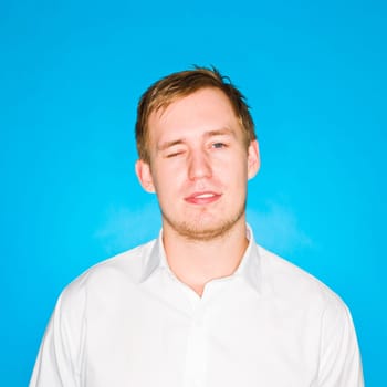 Portrait of a young man on blue background