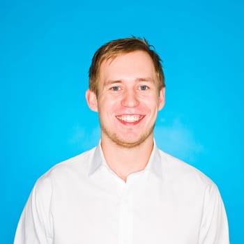 Portrait of a young man on blue background