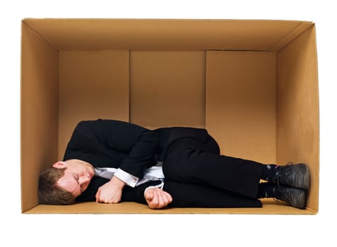 Sleeping in a cardboard box isolated on white background