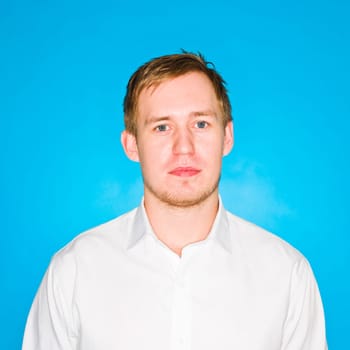 Portrait of a young man on blue background