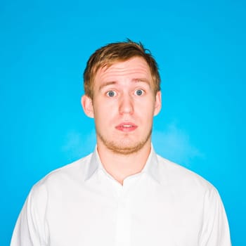 Portrait of a young man on blue background