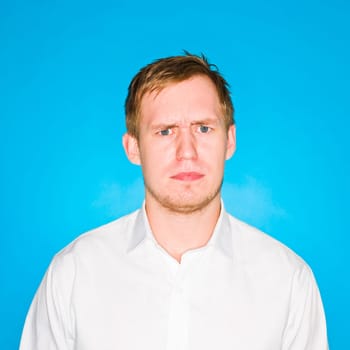 Portrait of a young man on blue background