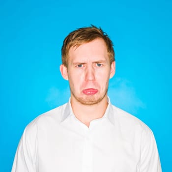 Portrait of a young man on blue background