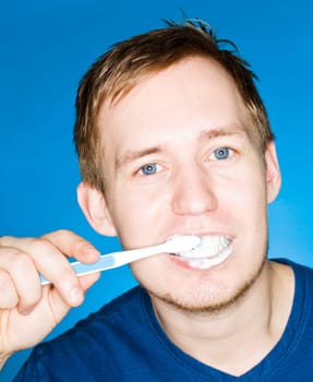 Close up of a man brushing teeths