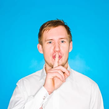 Portrait of a young man on blue background