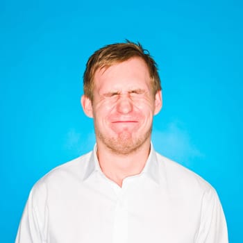 Portrait of a young man on blue background