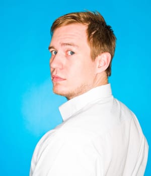 Portrait of a young man on blue background