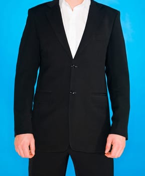 Part of a well dressed man on blue background