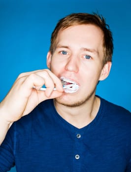 Close up of a man brushing teeths