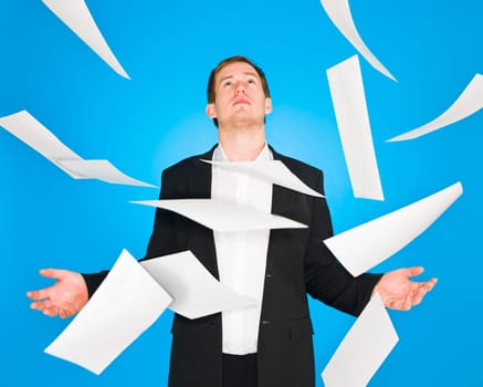 Man and flying papers on blue background