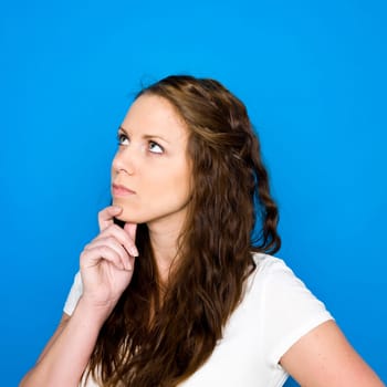 Portrait of a young girl on blue background