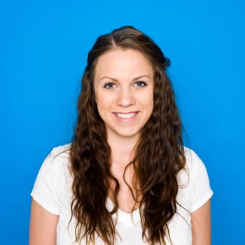 Portrait of a young girl on blue background
