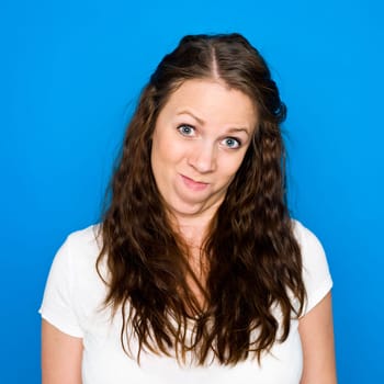 Portrait of a young girl on blue background