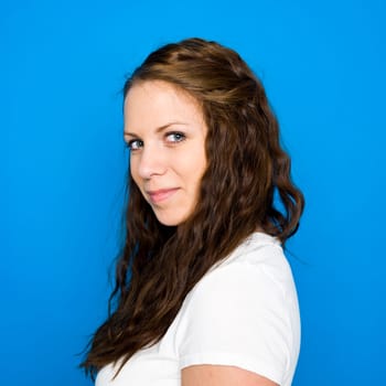 Portrait of a young girl on blue background