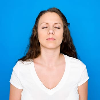 Portrait of a young girl on blue background