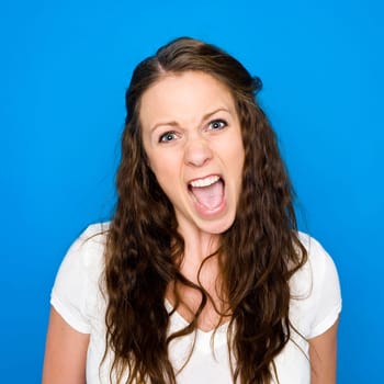 Portrait of a young girl on blue background