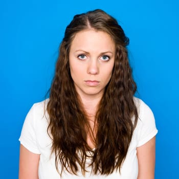 Portrait of a young girl on blue background