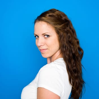 Portrait of a young girl on blue background