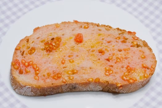 Catalan-style tomato rubbed on a slice of bread with oil and salt point