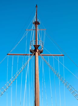 A Ships Mast and Rigging against a blue sky