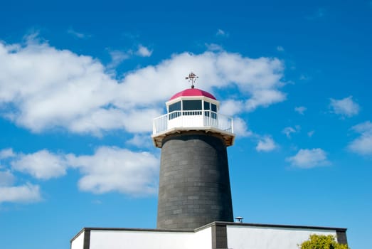 An Old Lighthouse in the Canary Islands with a sailing ship Weathervane