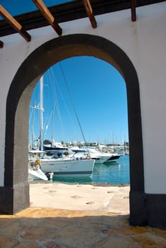Luxury Yachts Framed by a centuries old Archway inthe Canary Islands