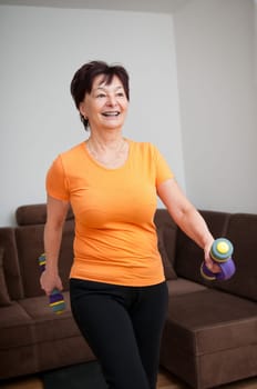 Senior woman exercising with barbells