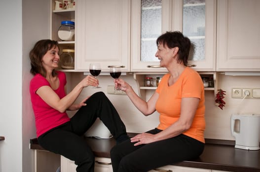 Happy life - mother and daughter drinking wine