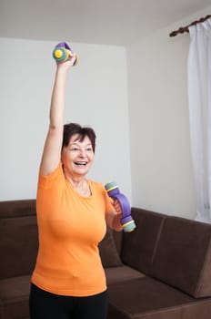 Senior woman exercising with barbells