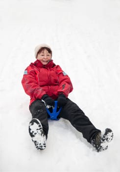 Senior woman on sledge - winter snow activity