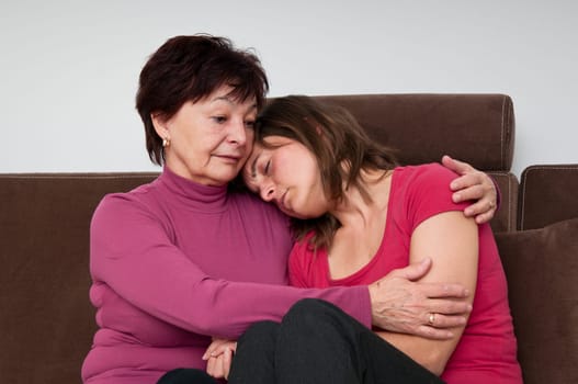 Big troubles - senior mother comforts daughter