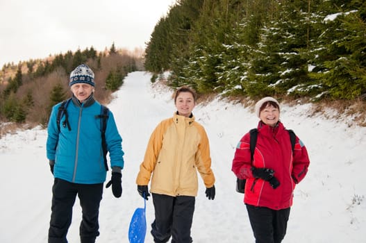 Family in winter together walking in snow
