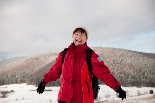 Winter portrait of senior mature in mountain snowy land