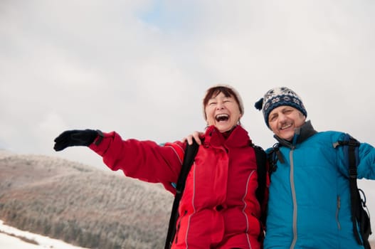 Winter fun - senior retired couple in snow
