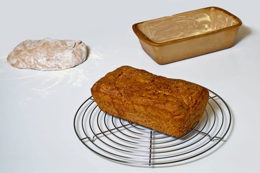 Wholemeal bread with dough and baking pan