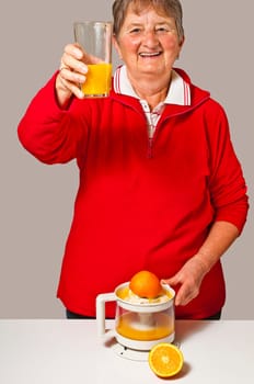 Senior citizen squeezes orange juice