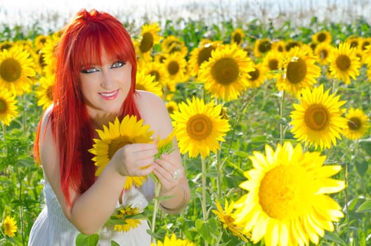 A woman smiling on a sunflower field