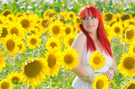 Young pretty woman on a sunflowers background