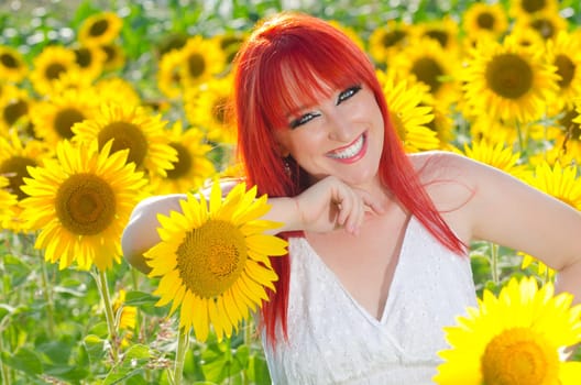 A woman smiling on a sunflower field