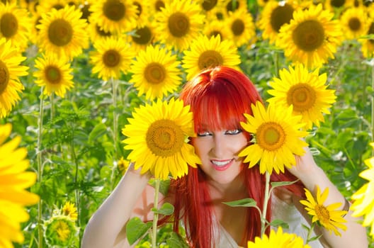 A young woman is playing on a sunflower field