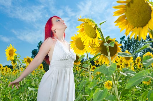 A young girl breathes the fresh air of nature